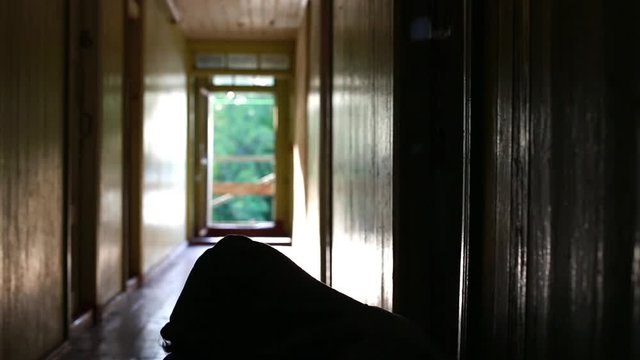Depression sinks in for man in dark hallway