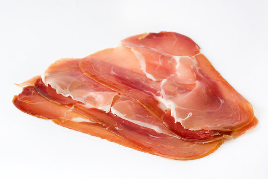 Thin slices of spanish serrano ham isolated on white background
