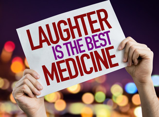 Laughter is the Best Medicine placard with night lights on background