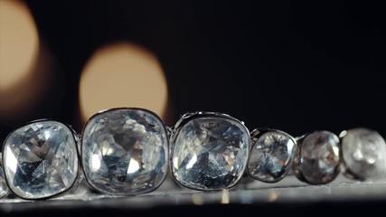 Diamond necklace with large stones falling on the table - Powered by Adobe