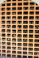 vintage wine bottles stacked in the wine cellar