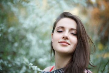 Naklejka premium Beautiful blonde woman in blooming garden. Bride.