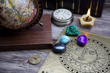 Ancient astrology. Old astrology globe and books with lighting candle