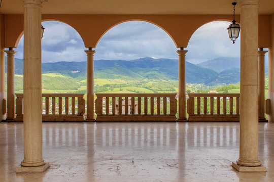 Panorama of hills in Umbria, Italy, seen through three arches