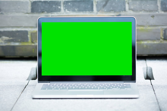 The blank and green screen of laptop.
