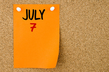 7 JULY written on orange paper note