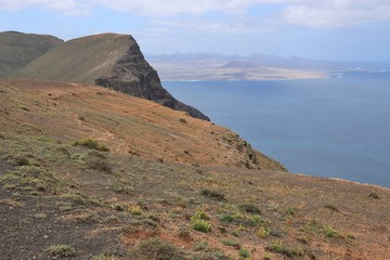 Fototapeta na wymiar On a high plateau of the Chinijo Archipelago nature park. Famara cliffs and ocean. North Lanzarote, Canary Islands, Spain.
