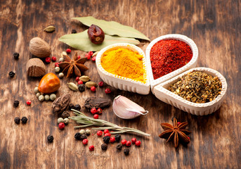 Seasonings, spices on a wooden background