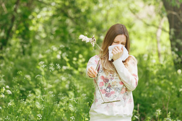 Fototapeta premium young woman suffering spring pollen allergy