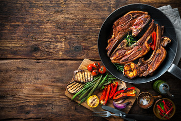 Roasted lamb meat with vegetables on grill pan