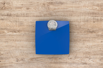 blue weight scales on wooden background