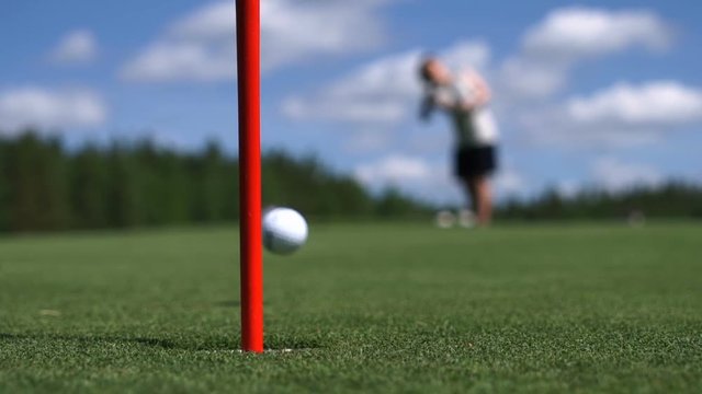 The man hits the Golf ball. Golf course