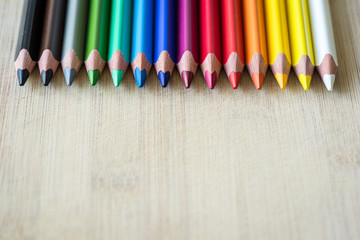 Obraz premium Color Pencils on wood texture. Macro shot of colorful pencils. Horizontal view of pencils.