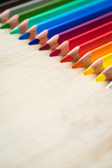 Obraz premium Color Pencils on wood texture. Macro shot of colorful pencils. Vertical view of pencils. Selective focus.