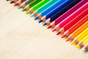 Obraz premium Color Pencils on wood texture. Macro shot of colorful pencils. Horizontal view of pencils.