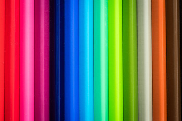 Obraz premium Color Pencils on wood texture. Macro shot of colorful pencils. Horizontal view of pencils.