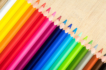 Obraz premium Color Pencils on wood texture. Macro shot of colorful pencils. Horizontal view of pencils.