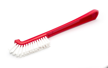 red plastic brush on a white background