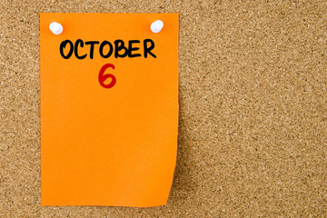 6 OCTOBER written on orange paper note