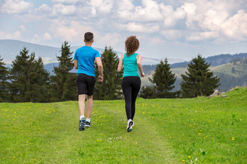 Young couple running in nature