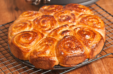 Baked sweet rolls cooling on a wire grid