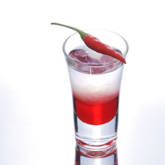 Colorful layered shot with reflection. Alcohol red shooter with chili pepper