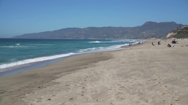 People enjoy the beach at Point Dume