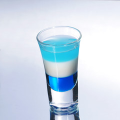 Colorful layered shot isolated on white gray gradient background with reflection. Alcohol shooter
