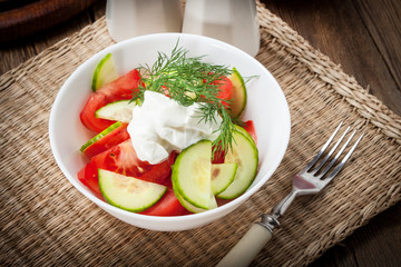 Fresh salad in white bowl.