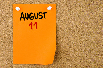 11 AUGUST written on orange paper note