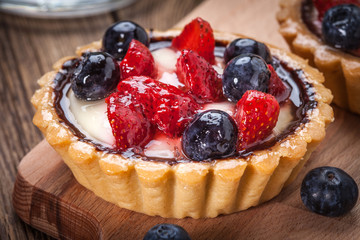 Fresh homemade fruit tart with strawberries and blueberries.