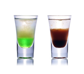 Set of colorful alcoholic cocktails in shot glasses isolated on white with reflection. Colletion of shooters