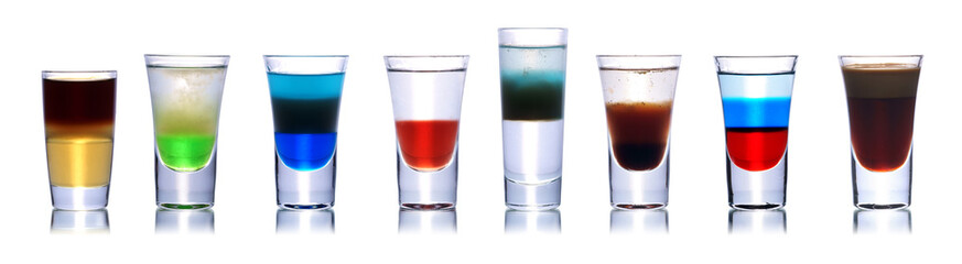 Set of colorful alcoholic cocktails in shot glasses isolated on white with reflection. Colletion of...