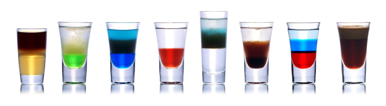 Set of colorful alcoholic cocktails in shot glasses isolated on white with reflection. Colletion of shooters