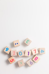 Top view on wooden cubes with numbers on a white background. Education and learning concept. 2017 school year. Flat lay.