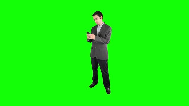 Businessman with a iPad tablet on a green screen chroma key background easy to replace with your content. Shot in 4K UHD resolution.