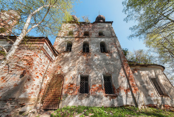 Fototapeta premium Quadrangle abandoned russian temple with old iron gates and windows
