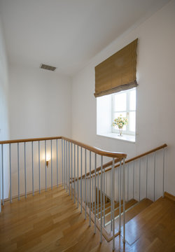 Two-storey studio apartment. Interior. A wooden staircase.