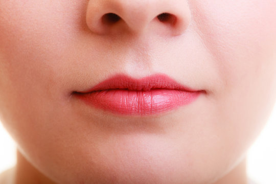 Closeup part of woman face red lips makeup detail.