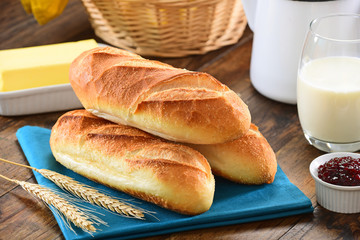 Fresh baguettes on wooden background