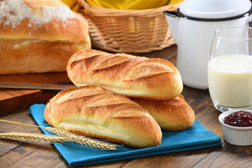 Fresh baguettes on wooden background