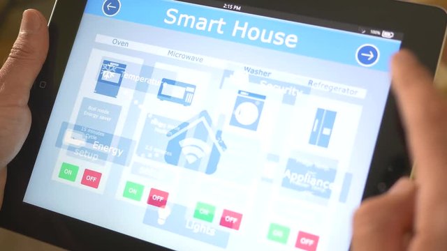 Smart house automation application on tablet iPad controling the appliances (microwave, washing machine, oven, fridge) of the building. 