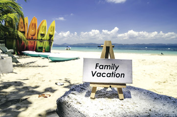 white canvas frame and wooden tripod on the tropical beach backg