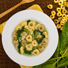 Tortellini Soup with Peas and Spinach. Selective focus.