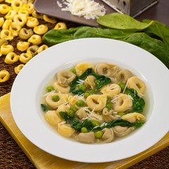 Tortellini Soup with Peas and Spinach. Selective focus.
