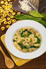 Tortellini Soup with Peas and Spinach. Selective focus.