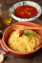 Bowl of pasta all 'egg and bowl with tomato sauce and oil cruet