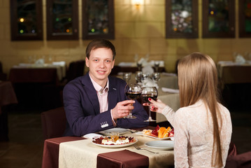 Couple toasting wineglasses in a luxury restaurant