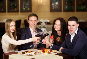 Friends at a restaurant drinking wine.