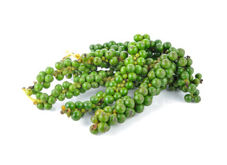 green peppercorns on white background